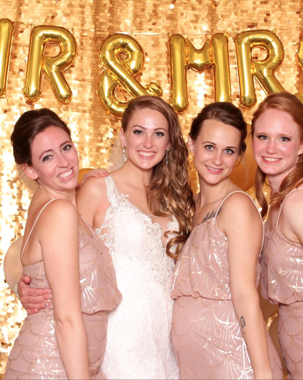 Bridesmaids posing in a wedding photo booth